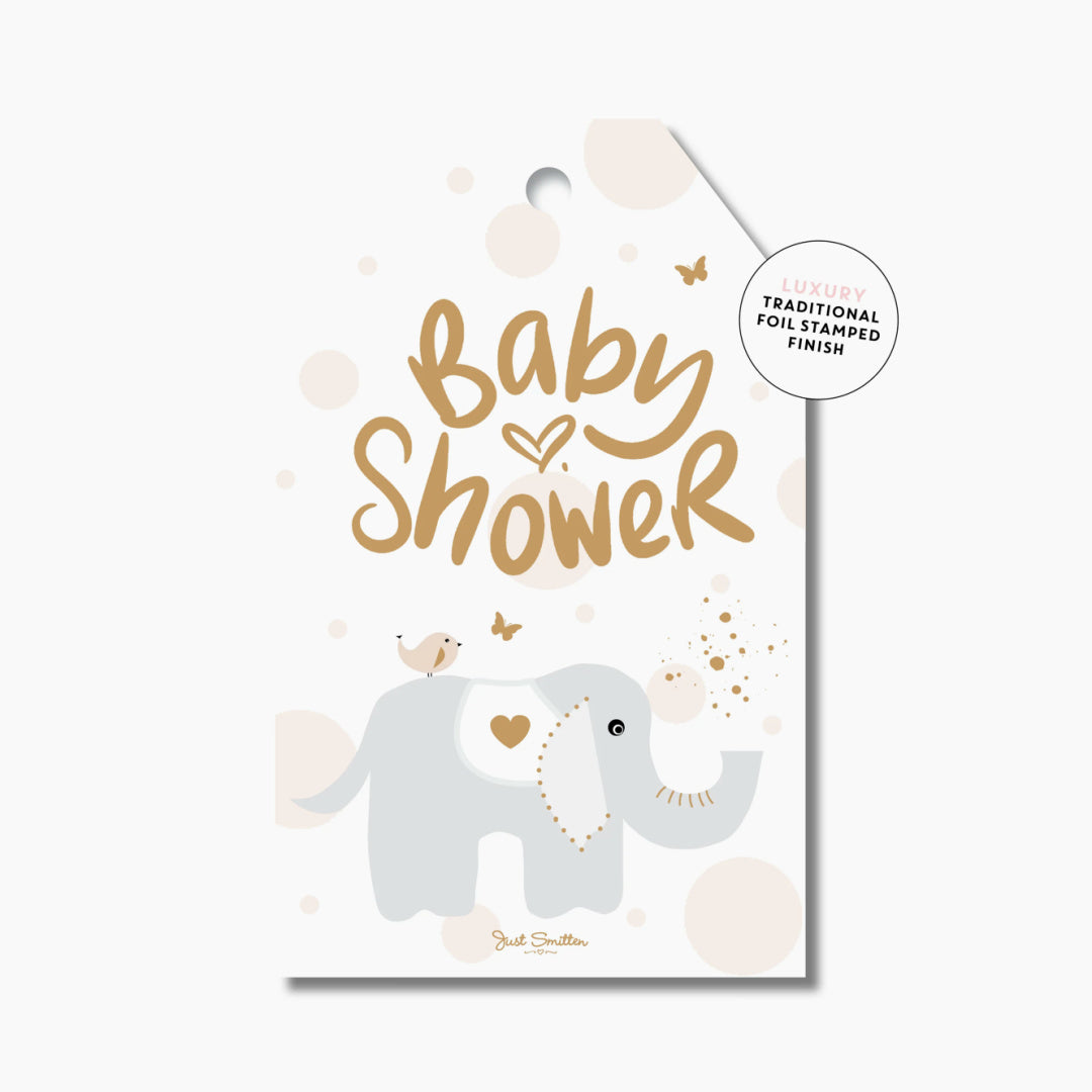 A gift tag with a illustration of a baby elephant and the text 'Baby Shower' in gold foil details.